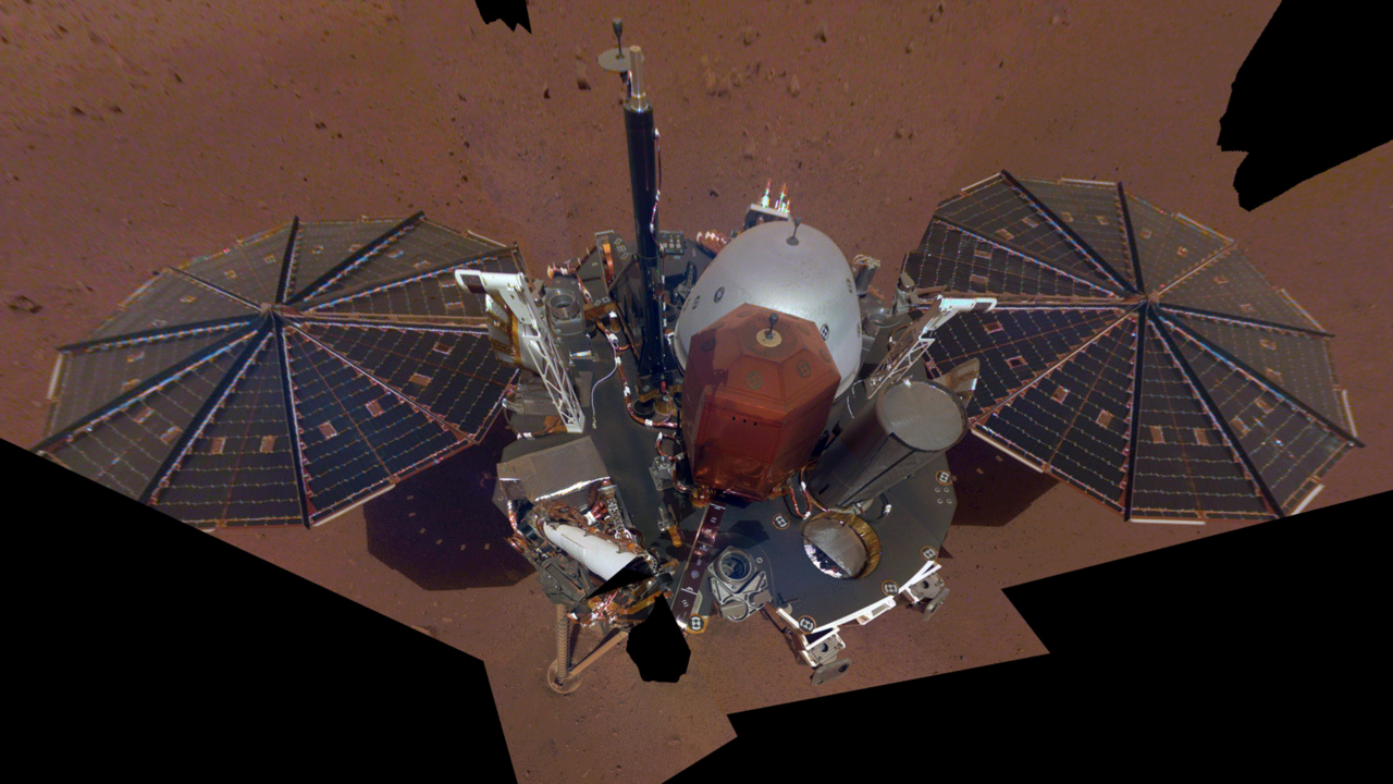 This is NASA InSight's first full selfie on Mars. It displays the lander's solar panels and deck. On top of the deck are its science instruments, weather sensor booms and UHF antenna.