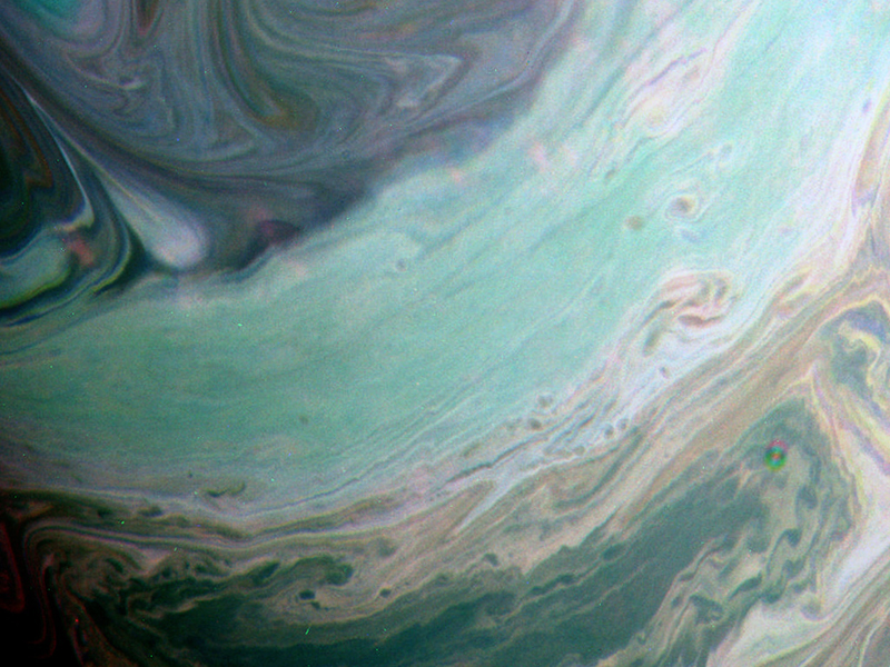 Color enhanced image of Saturn's swirling clouds.